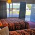 Scottish Inns Mcminnville guest room with two beds and a sliding glass door to the parking lot