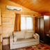 Canada Hotel & Bungalows in Cirali guest room with sofa, wardrobe and wood-paneled walls