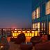 Sheraton Zibo Hotel rooftop terrace with city skyline view and lit lounge seating at dusk