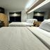 Microtel Inn & Suites by Wyndham Albertville guest room with two beds, desk, TV, and window