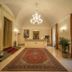 Palazzo San Lorenzo in Colle di Val d'Elsa lobby with chandelier, ornate rug and front desk