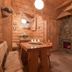 Dom Wypoczynkowy U Staszla in Bańska cozy rustic wooden room with stone fireplace and table