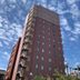 Sakai Sun Hotel Ishizugawa in Sakai, tall red hotel building under a partly cloudy sky