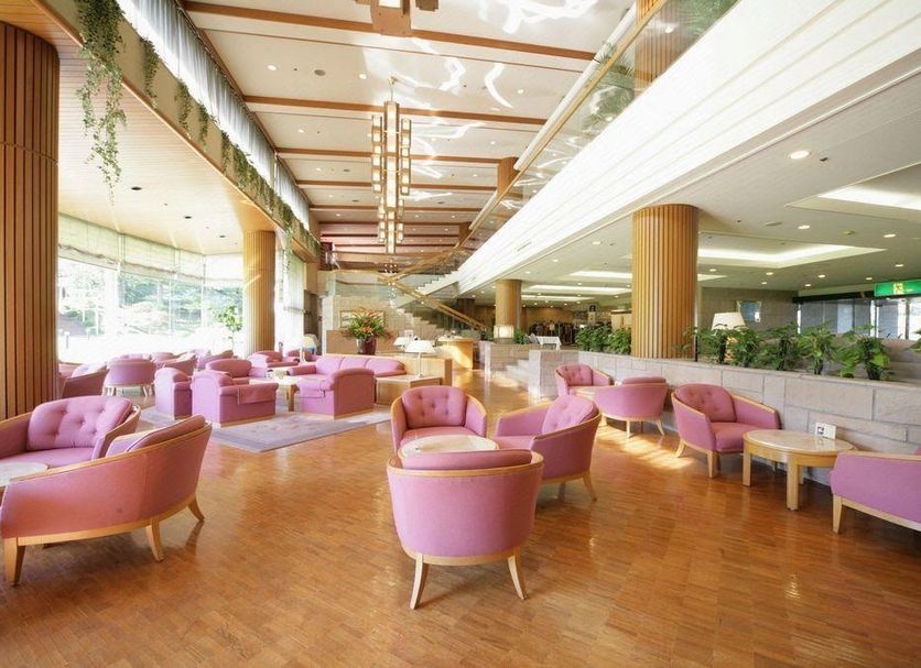Akiu Resort Hotel Crescent in Sendai lobby with pink lounge chairs, wood floor, and tall windows