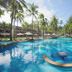 Katathani Phuket Beach Resort in Karon with a tropical lagoon pool, palm trees, and sun loungers
