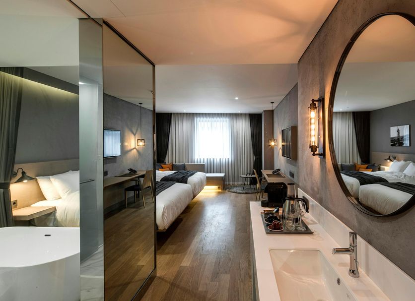 Hotel28 Myeongdong Seoul room with bed, desk, mirror, and city window view
