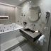 Hotel della Valle Agrigento bathroom with whirlpool tub, marble sink and round mirror