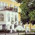 Tyringe Kurhotell in Hässleholm with yellow facade, arched windows, balcony, and front steps