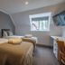 Winchelsea Lodge room in Winchelsea with two twin beds, skylight window, and wall-mounted TV