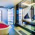 Impiana Private Villas Kata Noi in Karon: ocean-view bathtub beside a glass-walled bedroom and shower
