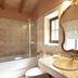 Bathroom at Agroturismo Es Quatre Cantons in Binissalem with bathtub, vanity sink and ornate mirror