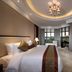 New Century Hotel Guian Guizhou bedroom in Anshun with large windows and a balcony view