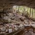 Carter Caves State Resort in Olive Hill overlooking a rocky cave entrance and forest trail