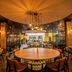 Kents Hill Park Training & Conference Centre in Milton Keynes dining room with round tables and warm lighting