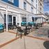 Hampton Inn ATL-Lawrenceville-I-85-Sugarloaf patio with tables, seating, and outdoor fireplace in Lawrenceville