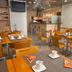 La City Estación Alicante hotel breakfast room with tables, chairs, and bar seating
