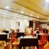 Hotel Belvedere in Caserta dining room with set tables, wooden chairs, and warm ceiling lights