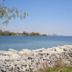 Humber College Lakeshore Residence in Toronto with lakefront rocks and distant city skyline