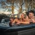 Western House Hotel Ayr couple relaxing in an outdoor hot tub at sunset