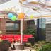 Outdoor lounge at Waldhotel Bärenstein in Horn-Bad Meinberg with red seating, umbrellas and lanterns