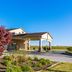 Red Roof Inn Vincennes exterior with covered entrance, landscaped drive, and clear blue sky