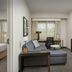 Residence Inn by Marriott Birmingham Hoover guest suite with sofa, desk, TV, and bedroom view