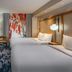 Fairfield Inn & Suites by Marriott Brunswick Freeport room with two beds, desk, chair and floor lamp