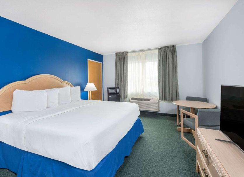 Days Inn by Wyndham Osage Beach Lake of the Ozarks guest room with king bed, window seat and TV