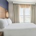 Residence Inn by Marriott Chicago Naperville/Warrenville bedroom with king bed, TV and window in Warrenville