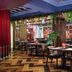 Cairn Hotel Newcastle Jesmond dining area with modern tables, booths and hanging greenery in Newcastle upon Tyne