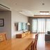 Elysian Gangchon Resort Chuncheon living area with sofa, TV, wood floor and large windows