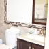 Arrowhead Mountain Inn Lake Arrowhead bathroom with tub, vanity, toilet, and mirror