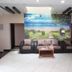 Sr Residency in Tiruchirappalli lobby with sofa seating and scenic wall mural