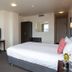 Distinction New Plymouth Hotel room with bed, desk, TV and wardrobe in New Plymouth