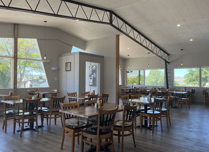 Sunglow Motel in Bicknell dining area with wooden tables, chairs, and large windows