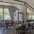 Sunglow Motel in Bicknell dining area with wooden tables, chairs, and large windows
