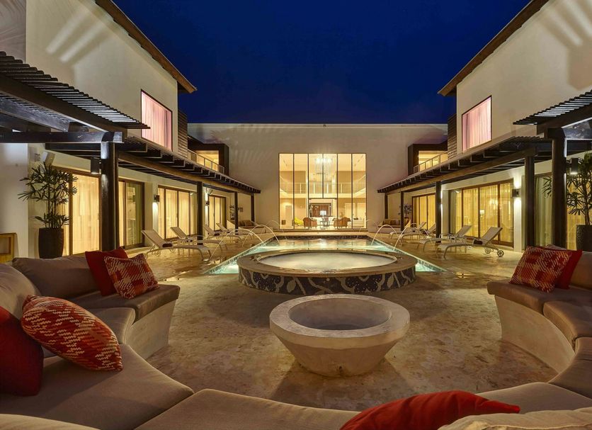 Royalton CHIC Punta Cana courtyard with lit pool and seating at night in Punta Cana