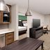 Residence Inn by Marriott New Orleans Elmwood guest suite with kitchenette, TV, sofa, desk and bed