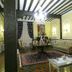 Hotel Palacio La Casona de Cerrazo lounge in Cerrazo with chandelier, arched windows, and patterned rug
