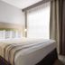 Country Inn & Suites by Radisson, Germantown, WI guest room with king bed and bedside lamps