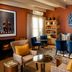 Le Quartier Francais lounge in Franschhoek with fireplace, velvet chairs, patterned rug and art