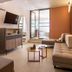 Hotel Blue Dream Palace Tripiti Resort in Limenaria, modern suite with sofa, TV, and balcony view