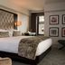 Westhouse Hotel New York guest room with king bed, tufted headboard and city-view window