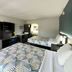 Studio 6 Suites Lafayette in Lafayette guest room with two beds, TV, and desk