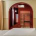 BYPILLOW The Citadel Madrid room with arched doorway, bed, and red accent wall