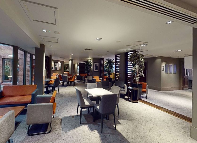 Village Hotel Swindon lobby lounge with seating areas and large windows in Swindon