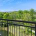 Balcony view at TownePlace Suites by Marriott Pigeon Forge overlooking trees and distant mountains