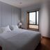Hotel A.S. Sao Joao da Madeira bedroom with queen bed, bedside lamps, and window view in São João da Madeira