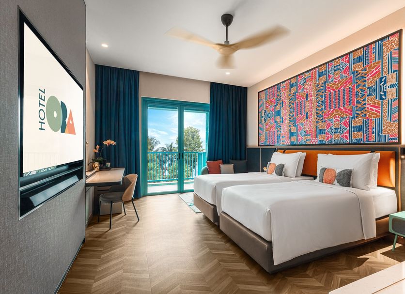 Resorts World Sentosa - Hotel Ora room in Singapore with twin beds, balcony, and colorful wall art