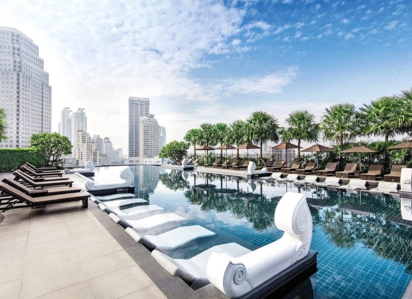 Grande Centre Point Terminal 21 Bangkok rooftop infinity pool with city skyline and loungers